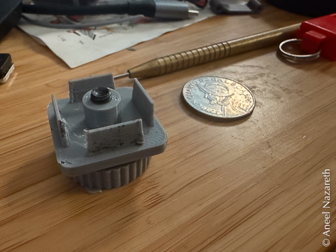 A gray plastic two-part device with fins for holding the inside of a square tube